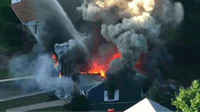 In this Sept. 13, 2018 file image from video provided by WCVB in Boston, flames consume the roof of a home following an explosion in Lawrence, Mass.