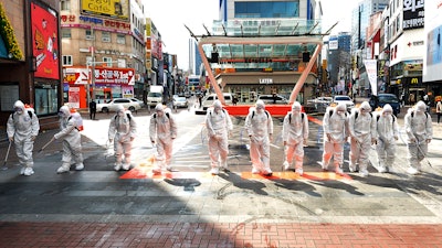 South Korean army soldiers wearing protective suits spray disinfectant to prevent the spread of the COVID-19 virus on a street in Daegu, South Korea, Thursday, Feb. 27, 2020. As the worst-hit areas of Asia continued to struggle with a viral epidemic, with hundreds more cases reported Thursday in South Korea and China, worries about infection and containment spread across the globe.