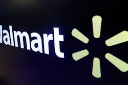 In this Feb. 18, 2020 file photo, the logo for Walmart appears above a trading post on the floor of the New York Stock Exchange. Walmart is confirming that it's developing a competitor to Amazon's juggernaut Prime membership program. The company declined on Thursday, Feb. 27 to offer details, but a spokeswoman said it will be called Walmart+.