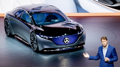 In this file photo Ola Kaellenius, CEO of Mercedes, stands next to a 'Vision EQS' car at the IAA Auto Show in Frankfurt, Germany.