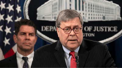 Attorney General William Barr, right, next to FBI Deputy Director David Bowdich, speaks during a news conference at the Justice Department in Washington.