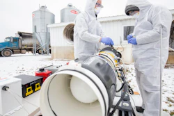Researchers Tian Xia and Zijie Lin test a plasma prototype for preventing airborne transmission of porcine reproductive and respiratory syndrome virus at a Michigan pig farm.