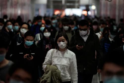 Residents of Hong Kong wear masks as they make their commutes.