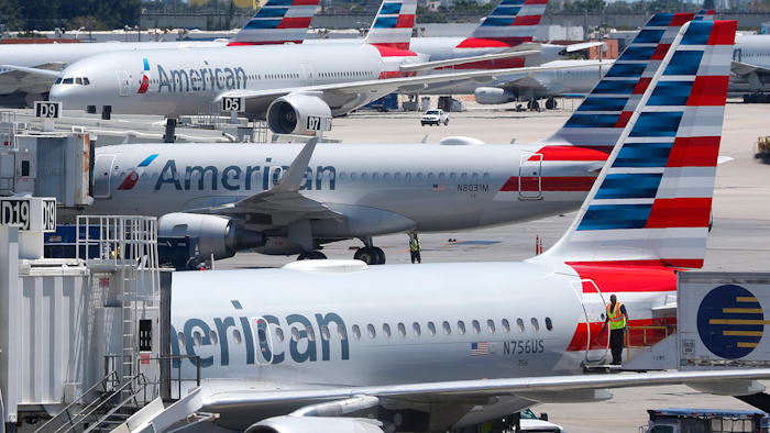 In this April 24, 2019, photo, American Airlines aircraft are shown parked at their gates at Miami International Airport in Miami. A veteran airline mechanic has been sentenced to three years in prison for sabotaging an American Airlines jetliner in Miami with 150 people aboard. The lawyer for 60-year-old Abdul-Majeed Marouf Ahmed Alani said at a hearing Wednesday, March 4, 2020, that the mechanic's sole motive in July was to earn overtime fixing the plane.