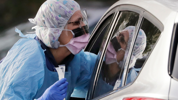Laurie Kuypers, a registered nurse, at a drive-through COVID-19 testing station in Seattle, March 17, 2020.