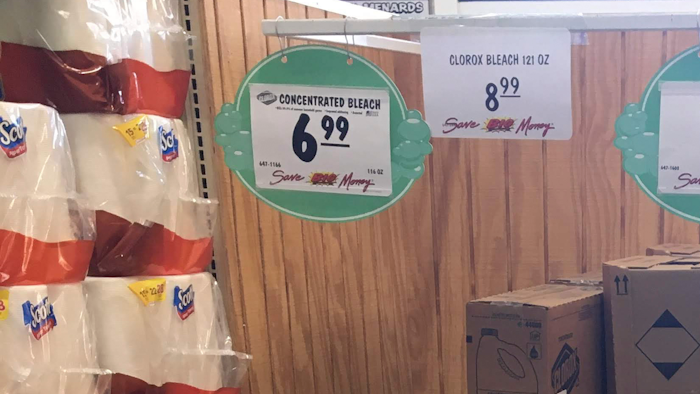 This March 10, 2020 photo made by an investigator with the Michigan Attorney General's Office shows gallons of Clorox bleach on display priced at $8.99 each at a Menards store in Jackson, Mich. A price sticker on an empty shelf elsewhere in the store listed a gallon of Clorox bleach as $4.47. A Menards spokesman told AP the price was different because Clorox recently began offering new, upgraded concentrations of bleach. The company was “disappointed” and taking the AG’s office cease-and-desist letter “very seriously.”