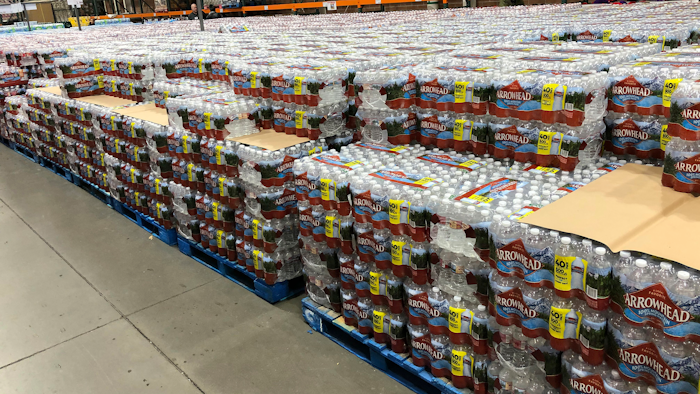 Cases of water sit in a Costco warehouse store as shoppers snap up bottled water in response to the coronavirus outbreak Thursday, March 19, 2020, in Sheridan, Colo.