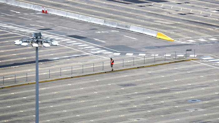 A man walks through empty passenger lanes at the Port of Dover, south east England, Friday March 20, 2020.