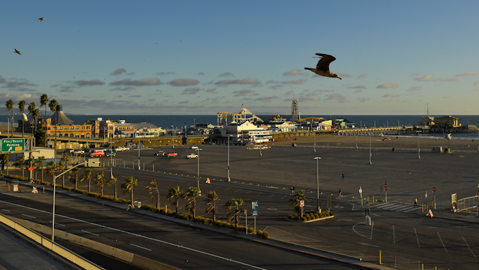 Light traffic and a mostly empty parking lot is seen along Pacific Coast Highway at the Santa Monica Pier, Monday, March 23, 2020, in Santa Monica, Calif.