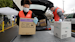 Volunteers Keshia Link, left, and Dan Peterson unload boxes of donated gloves and alcohol wipes from a car at a drive-up donation site for medical supplies at the University of Washington to help fight the coronavirus outbreak Tuesday, March 24, 2020, in Seattle.