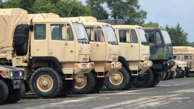 Military vehicles are lined up at a staging area at Fort McCoy, Wisconsin.