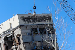 A wrecking ball smashes against the 'Leaning Tower of Dallas' north of downtown Dallas, Monday, Feb. 24, 2020. The still-standing structure is part of the 11-story former Affiliated Computer Services building that found a second life online after a Feb. 16 implosion attempt. The company that engineered the blast said some explosives did not go off.