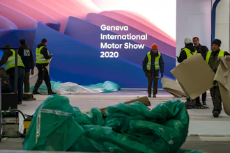 Workers dismantle a booth after that the 90th Geneva International Motor Show (GIMS) is cancelled by Swiss authorities, at the Palexpo in Geneva, Switzerland, Friday, Feb. 28, 2020. The 90th edition of the International Motor Show, scheduled to begin on March 5th, is cancelled due to the advancement of the (Covid-19) coronavirus in Switzerland. The Swiss confederation announced today that all events involving more than 1,000 people would be banned until 15 March.