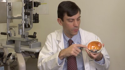 Dr. Jason Comander, inherited retinal disorder specialist at Massachusetts Eye and Ear Infirmary in Boston points to a model of an eye during an interview on Jan. 8, 2020.