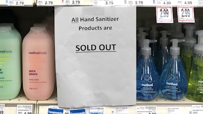 A sign on a shelf at a QFC grocery store in Kirkland, Wash., advises shoppers, Tuesday, March 3, 2020, that all hand sanitizer products are sold out.