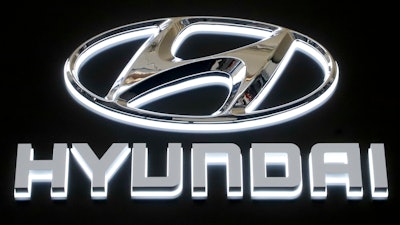 In this Feb. 14, 2019 file photo, this is the Hyundai logo on a sign at the 2019 Pittsburgh International Auto Show in Pittsburgh. Hyundai is joining affiliated automaker Kia in yet another U.S. recall for problems that could cause engine fires.Hyundai says Wednesday, March 4, 2020, that it's recalling nearly 207,000 Sonata midsize cars from 2013 and 2014 because a hose that connects one fuel pump to another can develop cracks, leak fuel and potentially cause a fire.