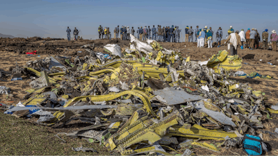 In this March 11, 2019, file photo, wreckage is piled at the crash scene of Ethiopian Airlines flight ET302 near Bishoftu, Ethiopia. The year since the crash of an Ethiopian Airlines Boeing 737 Max has been a journey through grief, anger and determination for the families of those who died, as well as having far-reaching consequences for the aeronautics industry as it brought about the grounding of all Boeing 737 Max 8 and 9 jets, which remain out of service.