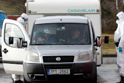 A member of the medical staff measures the temperature of a traveller at the border crossing with Germany in Rozvadov, Czech Republic, Monday, March 9, 2020. Czech authorities started on Monday random checks of arriving vehicles at the border crossings with Austria, Germany and Slovakia in reaction to the outbreak of the new coronavirus in Europe, particularly in Italy. As part of the move, officials measure the temperatures of some passengers in cars, trucks and buses.