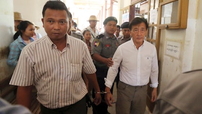 In the May 7, 2019, file photo, Myanmar national Shein Latt, left, and his boss U.S. national John Fredric Todoroki leave a local court after being arrested for operating a marijuana plantation in Ngazun Township, Mandalay region, central Myanmar. A Myanmar court on Tuesday sentenced Shein Latt to twenty years in prison under the country's drug laws concerning marijuana.