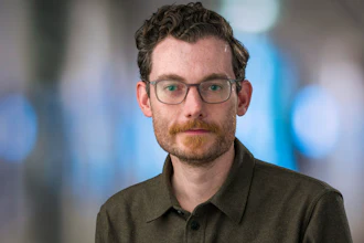 In this Feb. 7, 2019 photo provided by the Fred Hutch News Service, Trevor Bedford, a computational biologist at the Fred Hutchinson Cancer Research Center, poses at the center in Seattle. Bedford is among a group of scientists who are contributing data to the decision-making in Washington state with regards to containing the new coronavirus outbreak.