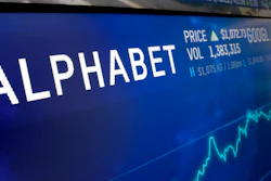 In this Feb. 14, 2018, file photo the logo for Alphabet appears on a screen at the Nasdaq MarketSite in New York. Google sister company Verily has launched a website to screen people who think they might have COVID-19 and point them to testing sites, but you probably still can't get tested. Verily, a health tech company owned by Google parent Alphabet, launched the screening tool Sunday, March 15, 2020 for those that live in or near Santa Clara County and San Mateo County in California's Silicon Valley.