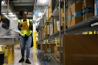 In this Dec. 17, 2019, file photo, Tahsha Sydnor stows packages into special containers after Amazon robots deliver separated packages by zip code at an Amazon warehouse facility in Goodyear, Ariz. On Monday, March 16, 2020, Amazon said that it needs to hire 100,000 people across the U.S. to keep up with a crush of orders as the coronavirus spreads and keeps more people at home, shopping online.