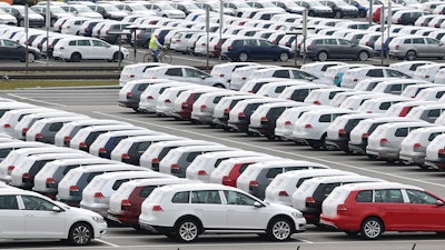 New Volkswagen vehicles are storage in a car park at the Volkswagen plant in Zwickau, Germany, Monday, March 17, 2020.German automaker Volkswagen says it is shutting down most of its European plants for two weeks due to the coronavirus outbreak. For most people, the new coronavirus causes only mild or moderate symptoms, such as fever and cough. For some, especially older adults and people with existing health problems, it can cause more severe illness, including pneumonia.