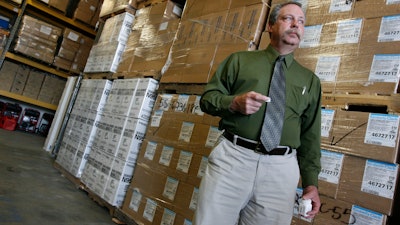 In this April 29, 2009, file photo, Don Wood, an official with the Strategic National Stockpile, awaits another truck load of medications in Salt Lake City, Utah during a swine flu outbreak from the H1N1 virus. The 2009 H1N1 pandemic prompted the largest use to date of the stockpile, which was created in 1999. It has never confronted anything on the scale of the current COVID-19 pandemic.