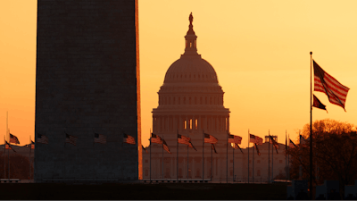 The Washington Monument and the U.S. Capitol are seen in Washington, at sunrise Wednesday, March 18, 2020. The White House has sent Congress an emergency $46 billion spending request for coronavirus-related funding this year.