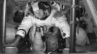 This March 26, 1971 photo made available by NASA shows astronauts Al Worden, center, Dave Scott, left, and Jim Irwin in the Command Module for an altitude chamber test at Cape Canaveral, Fla. Worden, who circled the moon alone in 1971 while his two crewmates tried out the first lunar rover, has died at age 88, his family said Wednesday, March 18, 2020.