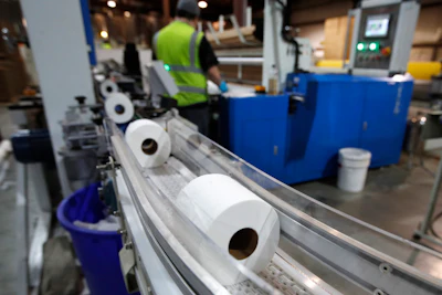 Toilet paper moves out from a cutting machine at the Tissue Plus factory, Wednesday, March 18, 2020, in Bangor, Maine. The new company has been unexpectedly busy because of the shortage of toilet paper brought on by hoarders concerned about the coronavirus.