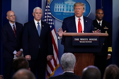 President Donald Trump speaks during press briefing with the coronavirus task force, at the White House, Thursday, March 19, 2020, in Washington. From left, Food and Drug Administration Commissioner Dr. Stephen Hahn, Vice President Mike Pence, Trump, and Surgeon General Jerome Adams.