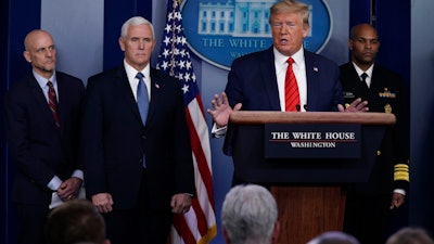 President Donald Trump speaks during press briefing with the coronavirus task force, at the White House, Thursday, March 19, 2020, in Washington. From left, Food and Drug Administration Commissioner Dr. Stephen Hahn, Vice President Mike Pence, Trump, and Surgeon General Jerome Adams.