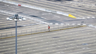 A man walks through empty passenger lanes at the Port of Dover, south east England, Friday March 20, 2020.