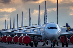 Vueling Airlines planes sit parked in a line at the Seville, Spain airport on Saturday, March 21, 2020, idled due to the COVID-19 coronavirus outbreak.