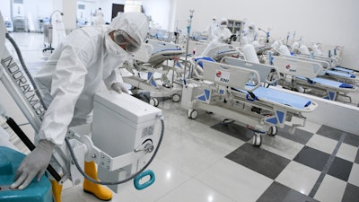 Staff inspect medical equipments at an emergency hospital set up amid the new coronavirus outbreak in Jakarta, Indonesia, Monday, March 23, 2020.
