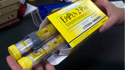 In this July 8, 2016, file photo, a pharmacist holds a package of EpiPens epinephrine auto-injector, a Mylan product, in Sacramento, Calif. On Tuesday, March 24, 2020, the U.S. Food and Drug Administration warned the public about malfunctions involving some EpiPens, the emergency injectors for severe allergic reactions.
