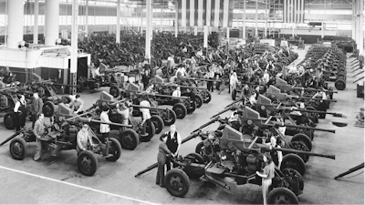 In this April 3, 1944, file photo Bofors guns used by the Army and Navy are shown lined up at the Firestone Tire & Rubber Co. in Akron, Ohio. Not since World War II when factories converted from making automobiles to making tanks, Jeeps and torpedos has the entire nation been asked to truly sacrifice for a greater good.