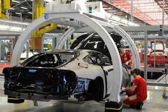 In this Wednesday, May 8, 2013 file photo, a technician works at the Ferrari department factory in Maranello, Italy.