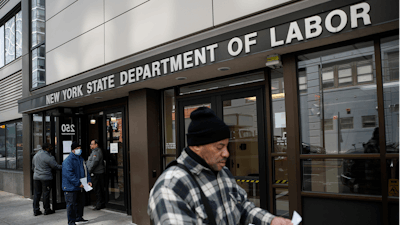 In this March 18, 2020 file photo, visitors to the Department of Labor are turned away at the door by personnel due to closures over coronavirus concerns in New York.