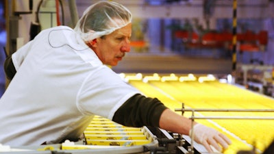 In this April 2, 2003 file photo, a worker at the Just Born factory in Bethlehem, Pa., keeps an eye on the Marshmallow Peeps that pass by on the conveyor belt.