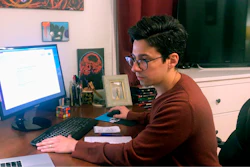In this March 25, 2020 image taken from video by Caillin Wells, neuroscientist Michael Wells works on the COVID-19 Pandemic Shareable Scientist Response Database in his home in Cambridge, Mass. Michael Wells started the shareable database that has, so far, gathered information from more than 7,000 scientists ready to lend their skills to fighting the coronavirus pandemic.
