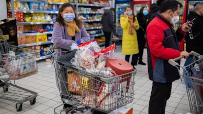 Shoppers in face masks as they line up at a grocery store in Wuhan, a city of 11 million, in central China’s Hubei Province. The urbanization of once densely forested areas of Asia and Africa have contributed to the spread of these deadly viruses.