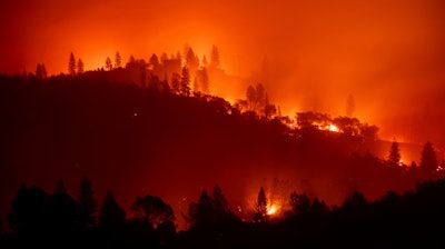 In this Nov. 10, 2018, file photo, the Camp Fire burns along a ridgetop near Big Bend, Calif.