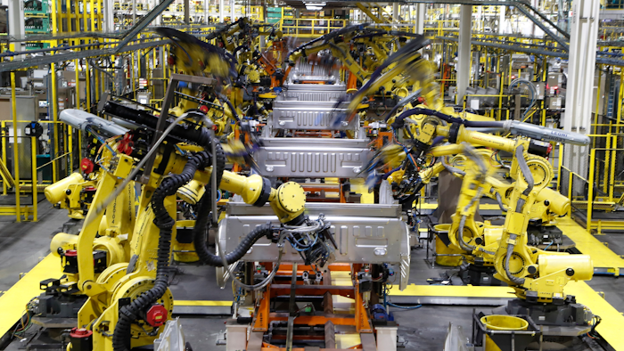 In this Sept. 27, 2018, file photo robots weld the bed of a 2018 Ford F-150 truck on the assembly line at the Ford Rouge assembly plant in Dearborn, Mich.