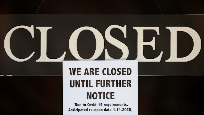 A notice of closure is posted at The Great Frame Up in Grosse Pointe Woods, Mich., Thursday, April 2, 2020. The coronavirus COVID-19 outbreak has triggered a stunning collapse in the U.S. workforce with millions of people losing their jobs in the past two weeks and economists warn unemployment could reach levels not seen since the Depression, as the economic damage from the crisis piles up around the world.