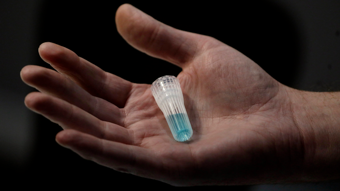 In this April 3, 2020, photo, blue preservation solution is shown at Spectrum DNA in Draper, Utah. The company has developed a test kit to detect the coronavirus in patients' saliva. At least two Utah companies have developed tests and gotten emergency authorization from the U.S. Food and Drug Administration: molecular diagnostics company Co-Diagnostics and ancestry-testing kit maker Spectrum DNA.
