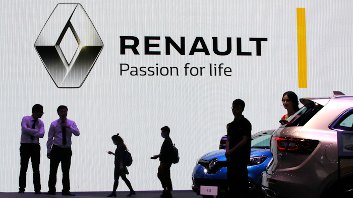 In this April 20, 2017, file photo, visitors walk past the Renault stand during the Auto Shanghai 2017 show in Shanghai, China.