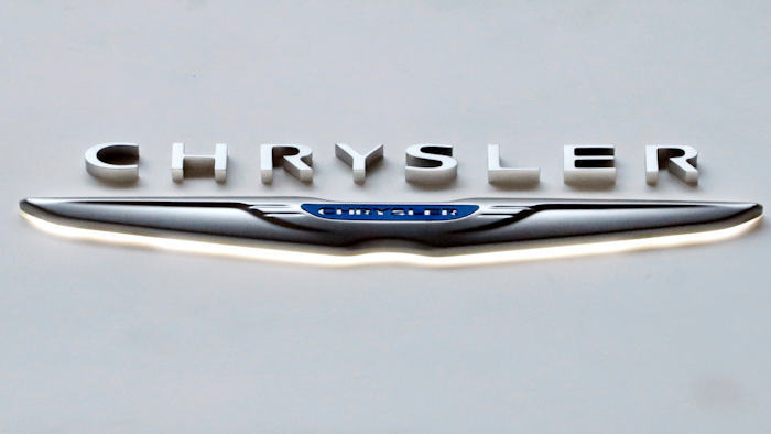 This Feb. 14, 2019 photo shows the Chrysler logo at the 2019 Pittsburgh International Auto Show in Pittsburgh. Fiat Chrysler is recalling more than 550,000 vehicles worldwide, Tuesday, April 14, 2020, because the windshield wiper arms can come loose and stop the wipers from working properly. The recall covers certain 2019 and 2020 Ram 1500, 1500 Classic pickups and Jeep Compass SUVs.
