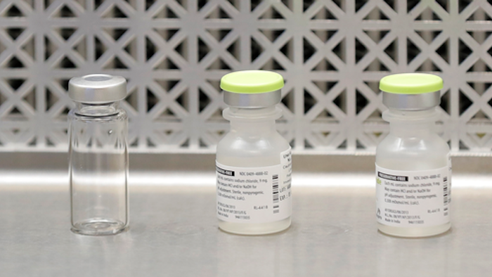 This March 16, 2020 file photo shows vials used by pharmacists to prepare syringes used on the first day of a first-stage safety study clinical trial of the potential vaccine for COVID-19.